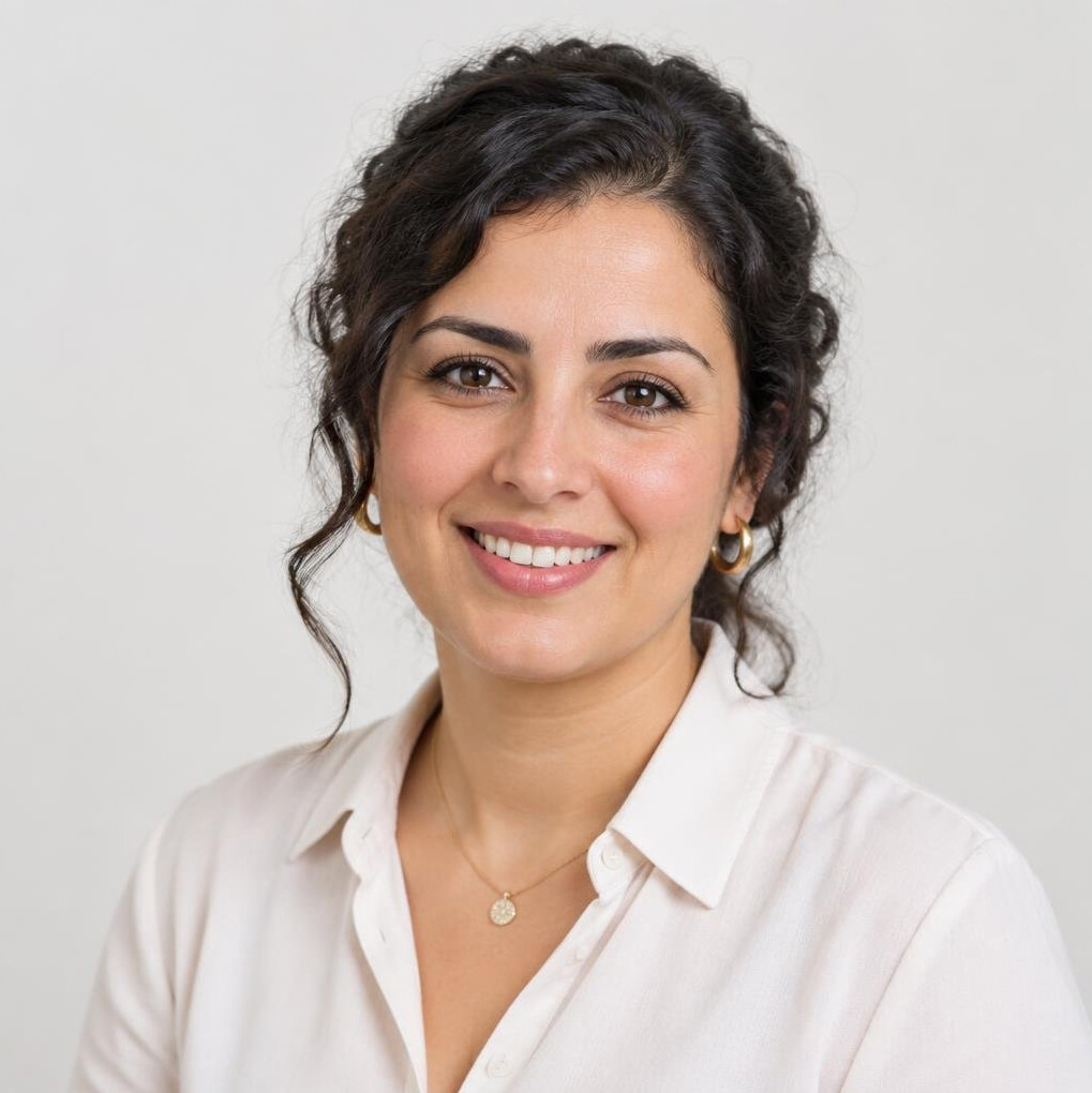 Studio portrait of a woman of North African descent smiling